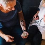 Hypertension: Symptoms, Causes, and Management Understanding Hypertension – Healthcare professional checking blood pressure for heart health assessment