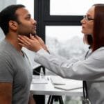 Thyroid Disease: Symptoms, Causes, and Prevention A doctor examines a patient’s neck for thyroid abnormalities during a routine check-up.