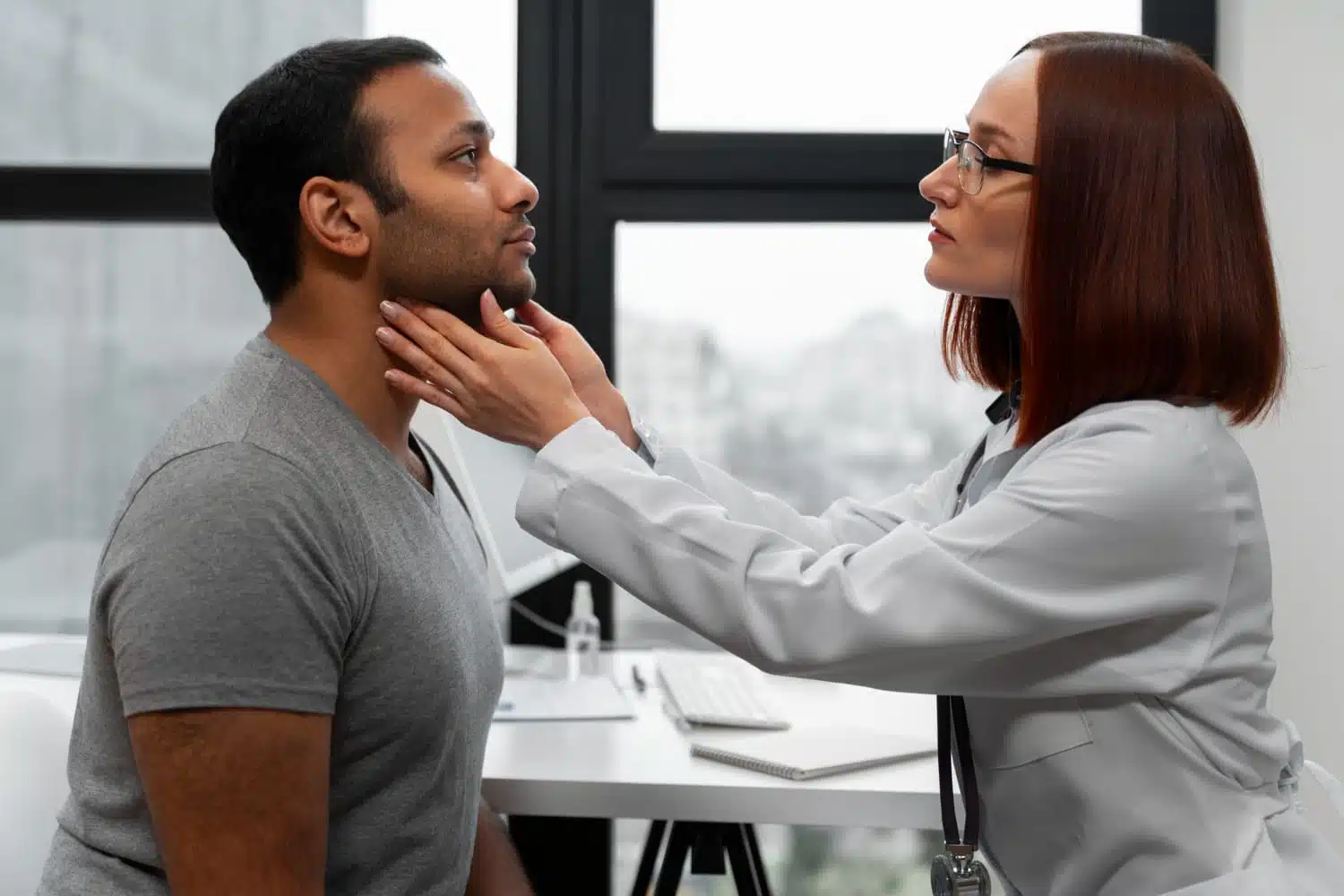 A doctor examines a patient’s neck for thyroid abnormalities during a routine check-up.