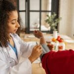 What Is Primary Care and Why Is It Essential for Your Health? A healthcare provider checks a patient's blood pressure in a warm, home-like setting.
