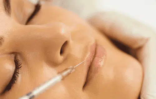 Woman receiving Botox injection for wrinkle reduction and facial rejuvenation.